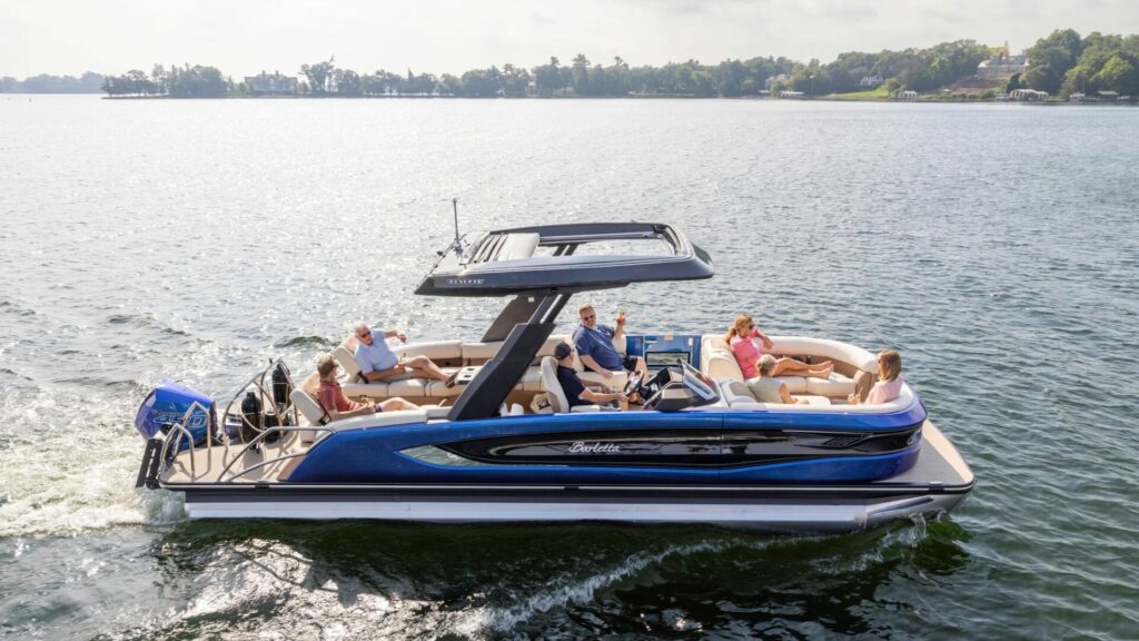 One of the Barletta pontoon boats on the water with a group of six people aboard. 