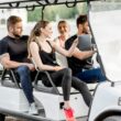 A group of people in a golf cart enjoying themselves.