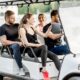 A group of people in a golf cart enjoying themselves.