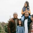 A family of five at a pine tree farm in the winter.