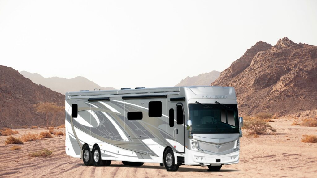 One of Fleetwood RV's motorhomes sat atop a desert landscape in the back.